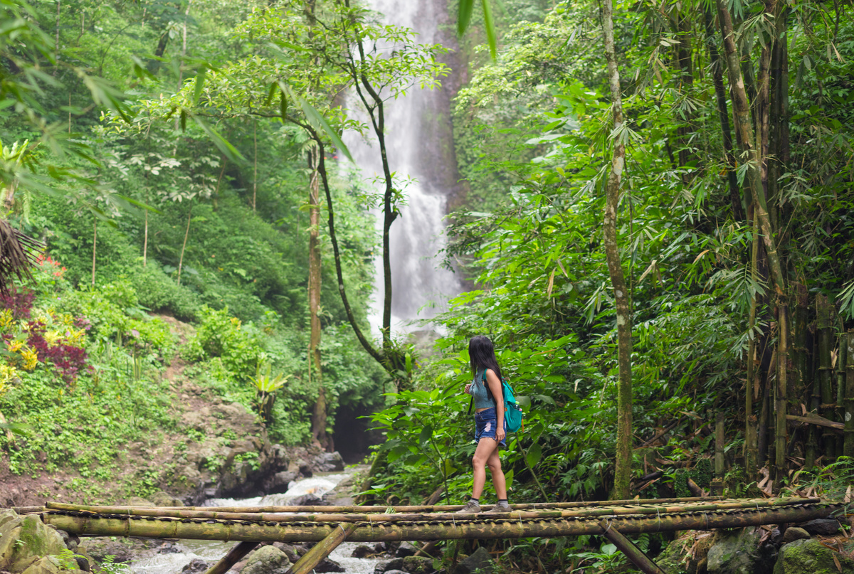 Tourist Woman Trekking in Bali Jungle